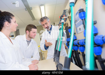 apprentices checking stock levels in store room Stock Photo
