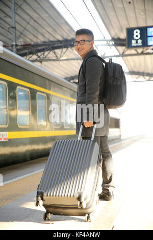 The young man at the station platform Stock Photo