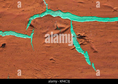 The cement wall was eroded by time. deterioration occurred.The brown ground was torn, seeing the old color inside was green. Stock Photo