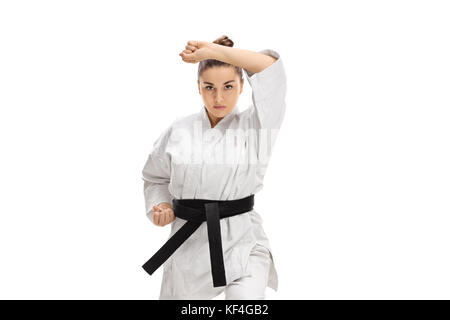 Girl in a kimono doing a karate kata isolated on white background Stock Photo