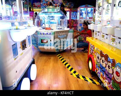 ANTIPOLO CITY, PHILIPPINES - OCTOBER 11, 2017: A dressmaker works on a  dress for a customer insider her shop Stock Photo - Alamy