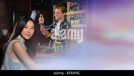 Digital composite of people at bar with transition Stock Photo