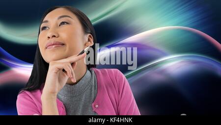 Digital composite of Woman looking up casually with colorful curves background Stock Photo