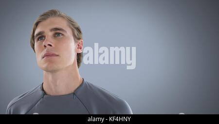 Digital composite of Man looking up with grey background Stock Photo
