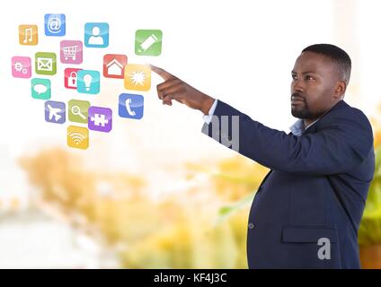 Digital composite of App interface and Businessman pointing touching air in front of greenery Stock Photo