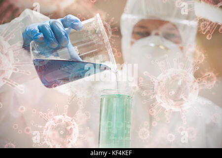 Red virus in human body against lab assistant with mask mixing blue liquid in beaker Stock Photo