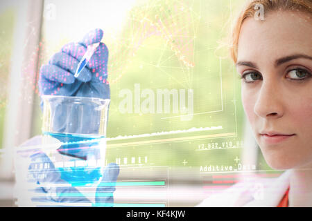 Helix diagram of DNA against scientist making chemical Stock Photo