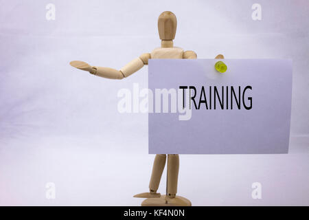 A Conceptual yellow Hand writing caption inscription written sticky note with word Training With black ink on a sticky note pinned to a hand of a sculpture Stock Photo