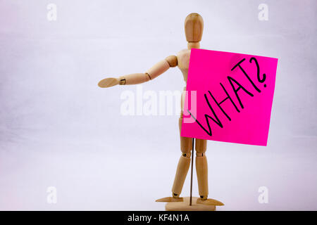 A Conceptual yellow Hand writing caption inscription written sticky note with word WHAT With black ink on a sticky note pinned to a hand of a sculpture Stock Photo