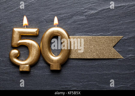 Gold number 50 celebration candle with glitter label Stock Photo