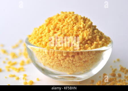 Lecithin granules in glass bowl isolated on white - a dietary supplement Stock Photo