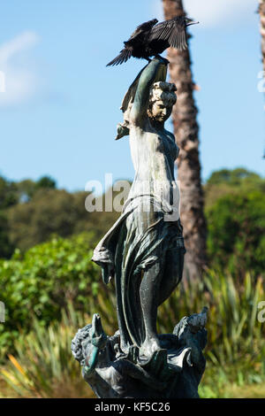Cormorant on statue in Royal Botanic Gardens lake, Sydney, Australia. Stock Photo