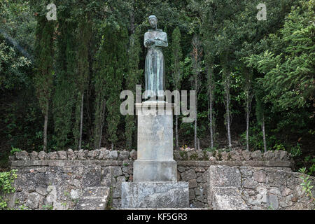 Statue of St Francis of Assisi on the grounds of Santa Maria de Montserrat Abbey, Monistrol de Montserrat,  Catalonia, Spain. Stock Photo