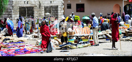 Maasai tribesmen in a colorful cattle and fresh produce market in Northern Tanzania. Stock Photo