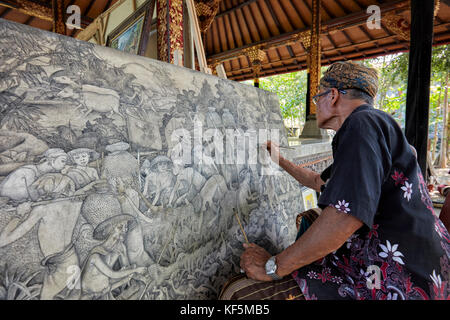 Local artist working at the Agung Rai Museum of Art (ARMA). Ubud, Bali, Indonesia. Stock Photo