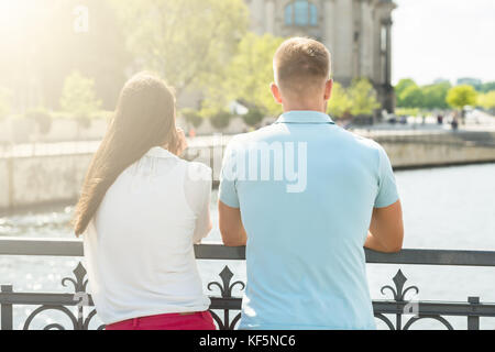 Rear View Of Man And Woman Enjoying View Stock Photo