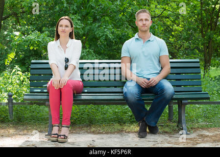 Shy Young Man And Woman  On First Date In Park Stock Photo