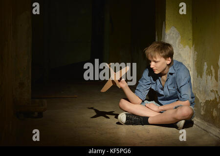 lonely little boy   in a dark cellar Stock Photo