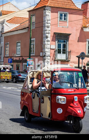 Lisbon Portugal,Belem,historic district,Rua de Belem,tuk-tuk,tricycle,cycle rickshaw,man men male,woman female women,driver,passenger passengers rider Stock Photo