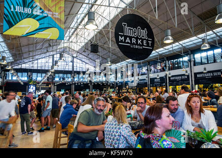 Lisbon Portugal,Cais do Sodre,Mercado Da Ribeira,Time Out Market,market hall,food court plaza,dining,tables,crowded,busy,Hispanic man men male,woman f Stock Photo