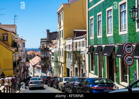 Lisbon Portugal,Bairro Alto,historic district,Principe Real,buildings,descending street,parked cars,residential apartment buildings,azulejos,painted t Stock Photo