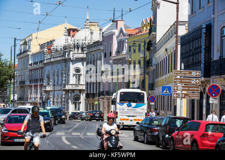 Lisbon Portugal,Bairro Alto,Praca do Principe Real,plaza,square,historic district,buildings,street sign,traffic,motorcycle,car,overhead trolley cables Stock Photo