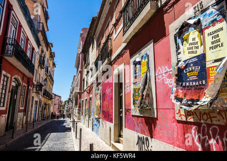 Lisbon Portugal,Bairro Alto,historic district,Principe Real,Rua da Rosa,neighborhood,buildings,cobblestone street,graffiti,old posted flyers,balconies Stock Photo