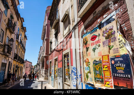 Lisbon Portugal,Bairro Alto,historic district,Principe Real,Rua da Rosa,neighborhood,buildings,cobblestone street,graffiti,old posted flyers,balconies Stock Photo