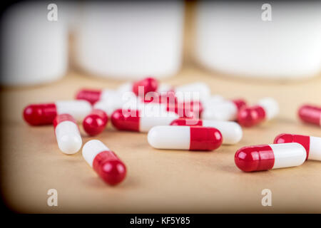 Pills spilling from an open bottle isolated on white background Stock Photo