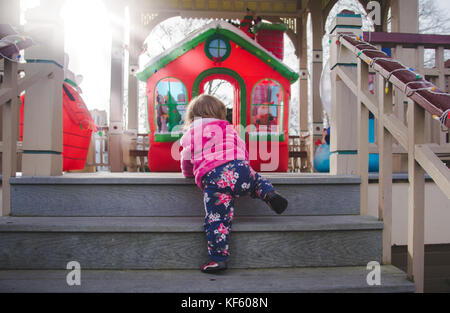 Toddler walking toward Christmas or holiday displays. Stock Photo