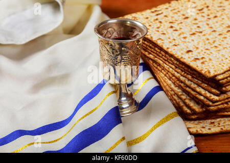 Silver wine cup with matzah, Jewish symbols for the Passover Pesach holiday. Passover concept. Stock Photo