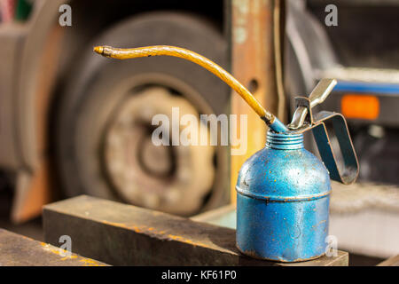 lubricant oil can and truck waiting for automobile mechanic checking in the garage Stock Photo
