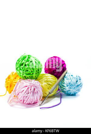 Colorful crocheting thread balls and needle isolated on white Stock Photo