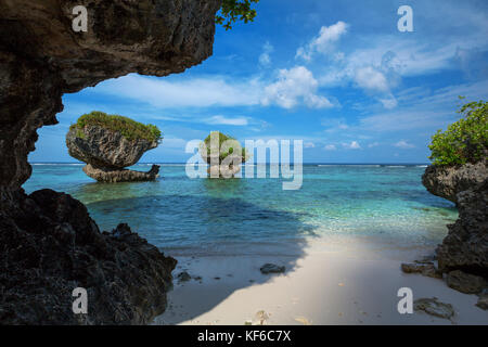 The clear, warm waters of Guam from Tanguisson Beach, looking through some of the rock islands, both on and off shore. Stock Photo