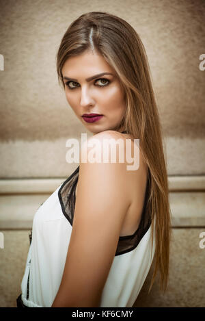 Serious young woman staring outdoors Stock Photo