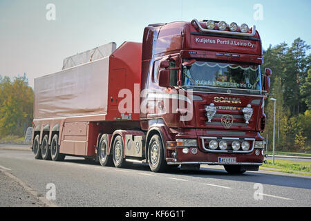 PARAINEN, FINLAND - OCTOBER 9, 2015: Red Scania Semi hauls concrete slabs in South of Finland. A concrete slab is common structural element of modern  Stock Photo