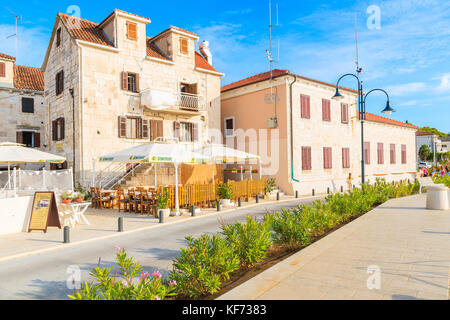 ROGOZNICA PORT, CROATIA - SEP 5, 2017: Street with restaurant and typical houses in Rogoznica old town on sunny summer day, Dalmatia, Croatia. Stock Photo