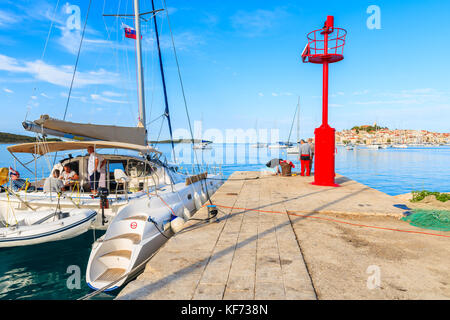 PRIMOSTEN PORT, CROATIA - SEP 5, 2017: Catamaran with tourists mooring in Primosten port, Dalmatia, Croatia. Stock Photo