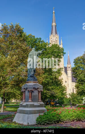 NOTRE DAME, IN/USA - OCTOBER 19, 2017:  Jesus Statue and Basilica of the Sacred Heart on the campus of Notre Dame University. Stock Photo