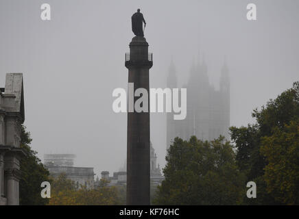 The Duke of York Column in St James's, London, looks out to the Palace of Westminster which is shroud in fog. Stock Photo