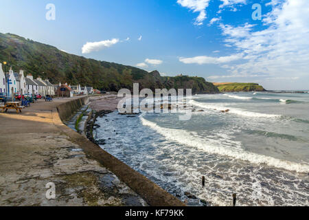 Looking west along the row of seafront cottages in the small Scottish fishing village of Pennan, Aberdeenshire, Scotland, UK Stock Photo