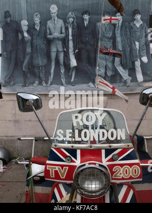 A poster from the film Quadrophenia hangs on a wall above a scooter in Brighton Stock Photo