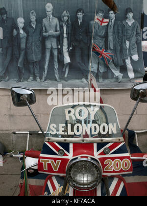 A poster from the film Quadrophenia hangs on a wall above a scooter in Brighton Stock Photo