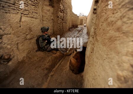 A U.S. Army soldier takes a break with a local Afghan dog during a patrol for Operation Enduring Freedom February 5, 2010 in Terot Kulacha, Afghanistan.    (photo by Kenny Holston via Planetpix) Stock Photo