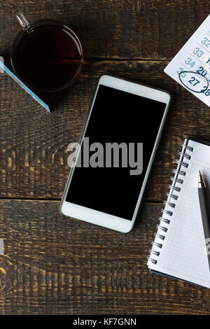 Payment card, phone, notebook and calendar on wooden boards vertical Stock Photo