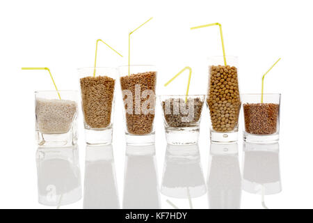 Different kinds of seeds and grains for healthy milk -  rice, soya, hemp, buckwheat and wheat milk. Grains in glasses isolated. Vegetarian and vegan m Stock Photo