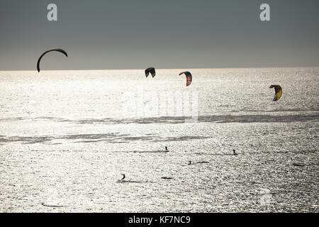 USA, California, Malibu, kite surfers play in the Pacific off of Broad Beach Stock Photo