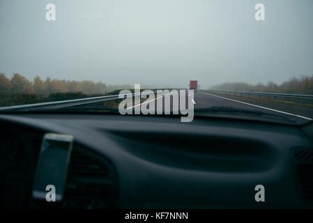 highway in fog view from car Stock Photo