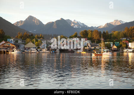 USA, Alaska, Sitka, a peaceful view of homes and fishing boats along the shore in Sitka Harbor at sunset, Crescent Bay Stock Photo