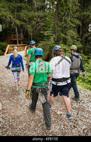 USA Alaska, Sitka, participants prepare for their 4-hour adventure where they will zip past massive spruce, cedars and glacially fed waterfalls, Grizz Stock Photo